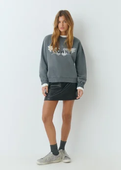 Falda mini efecto piel tachas