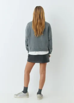 Falda mini efecto piel tachas