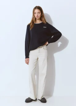 Pantalón corte lateral tachas