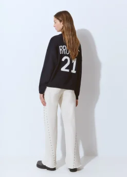 Pantalón corte lateral tachas